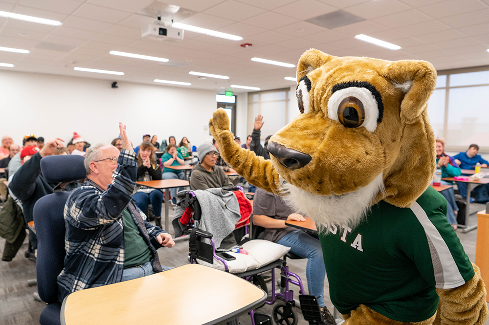 Cougie high-five with future student